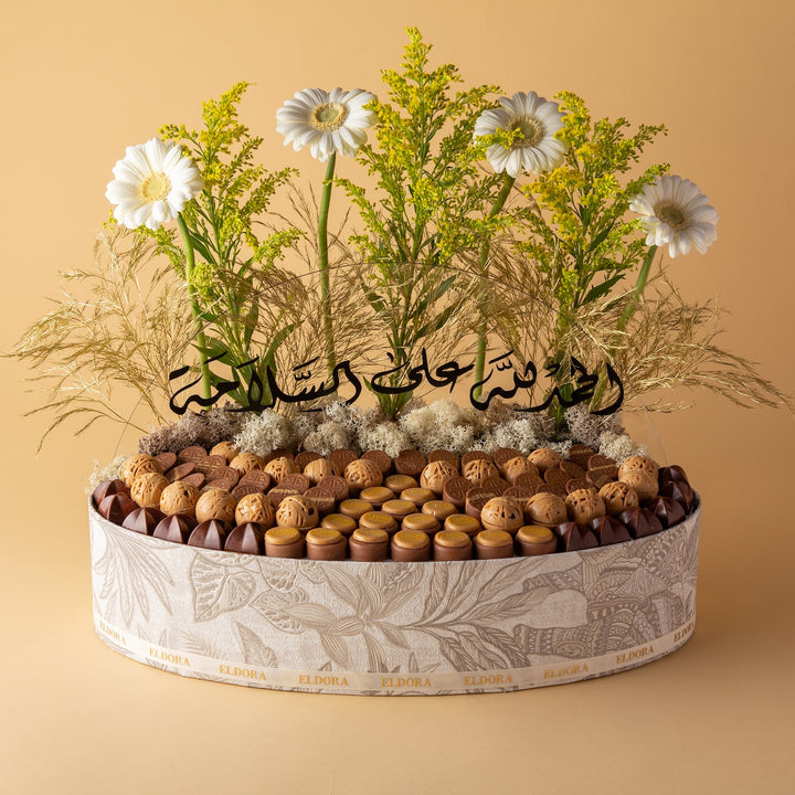 صينية جلد من التصاميم المميزه مزينة بالزهور مع تغريسة أكريليك تحتوي على 1.090 كيلو جرام من الشوكولاتة بحشوات نوتيلا ويفر، كيندر، برالين جوز الهند، جندويا برالين وكرسبي كراميل.